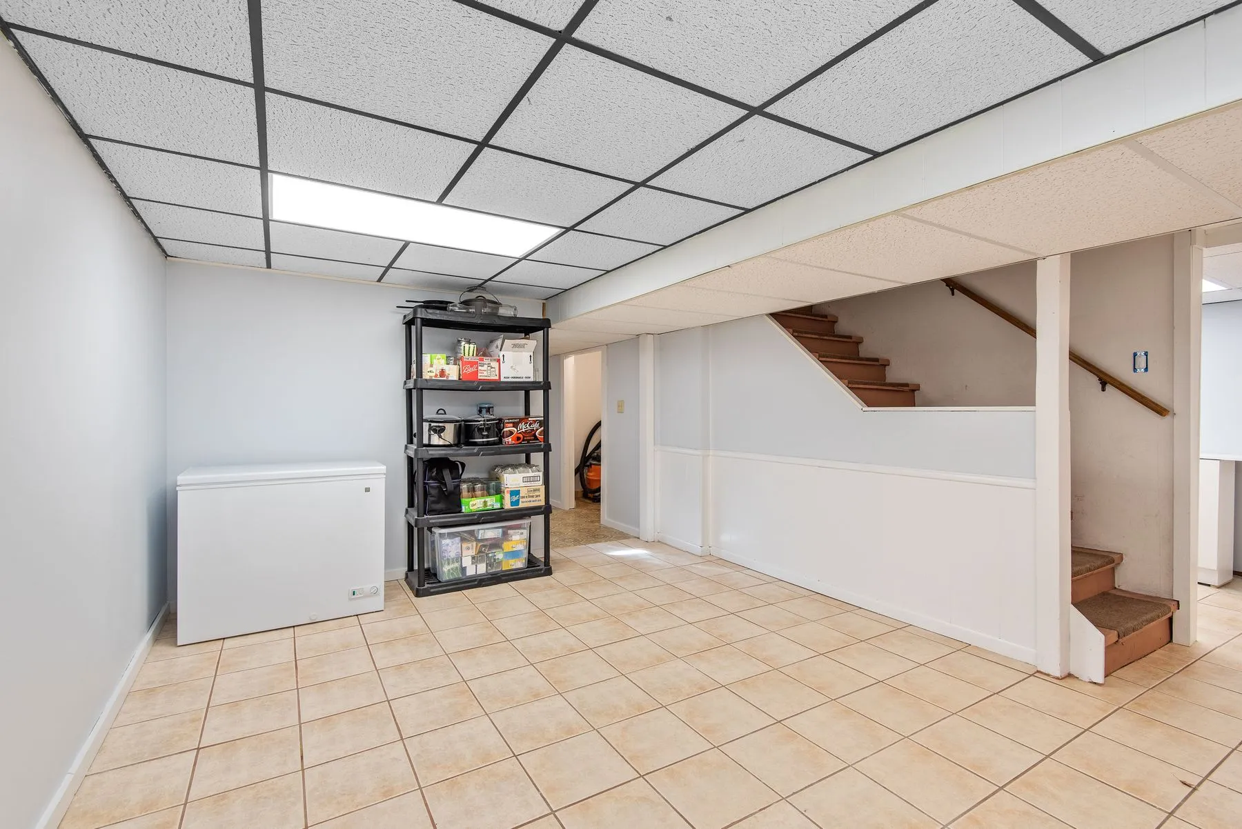 Unfinished basement with a poured concrete floor and a sump pit
